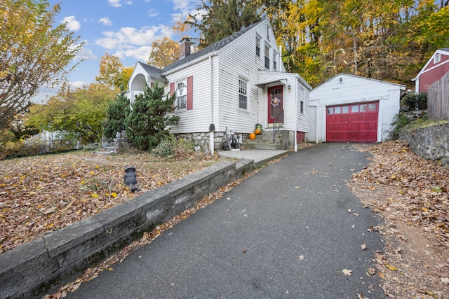 view of front of house with an outdoor structure and a garage