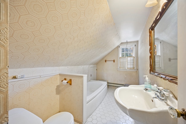 bathroom with lofted ceiling, a baseboard heating unit, toilet, a bath, and sink