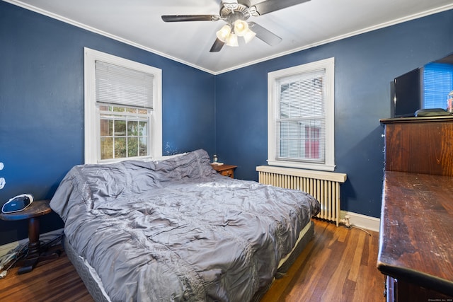 bedroom featuring crown molding, radiator heating unit, dark wood-type flooring, and ceiling fan