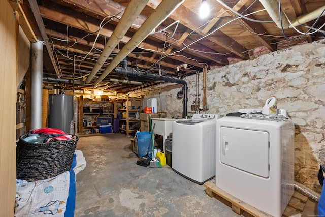 basement with water heater and separate washer and dryer