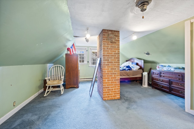 bedroom featuring baseboard heating, decorative columns, vaulted ceiling, a textured ceiling, and carpet flooring