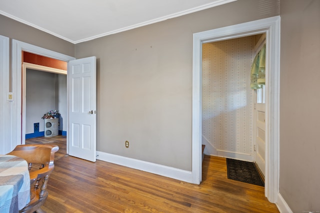 bedroom with ornamental molding and dark wood-type flooring