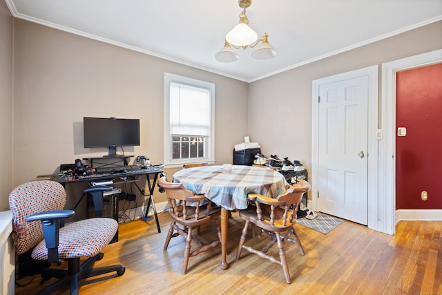 dining space featuring ornamental molding and light hardwood / wood-style flooring