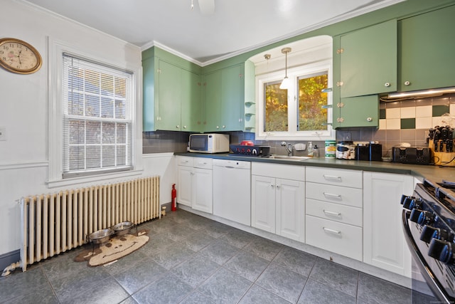 kitchen featuring white appliances, radiator heating unit, decorative light fixtures, white cabinets, and decorative backsplash