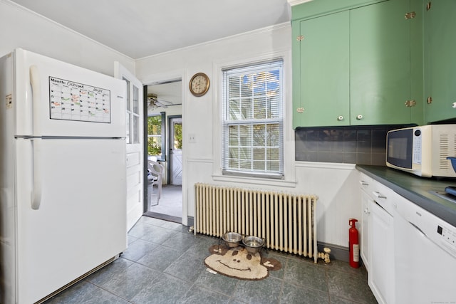 kitchen featuring white appliances, green cabinetry, radiator heating unit, ceiling fan, and decorative backsplash