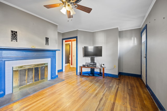 living room with ceiling fan, hardwood / wood-style flooring, and ornamental molding