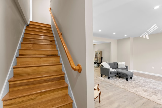 staircase with hardwood / wood-style flooring