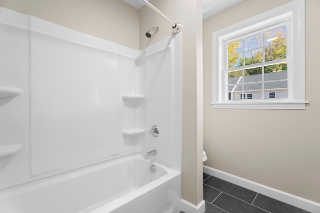 bathroom with shower / washtub combination, toilet, and tile patterned flooring