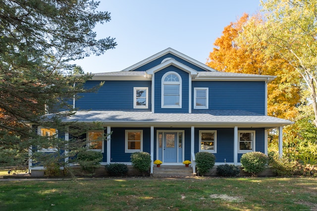 view of front facade with a front yard and covered porch