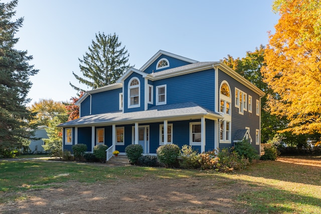 view of front of house featuring a front yard and a porch