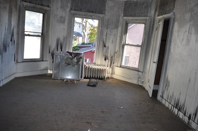 miscellaneous room with radiator heating unit and a healthy amount of sunlight