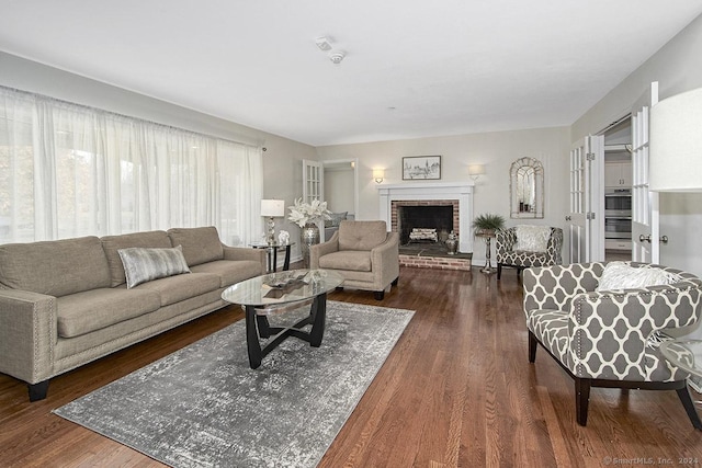 living room with dark hardwood / wood-style flooring and a fireplace