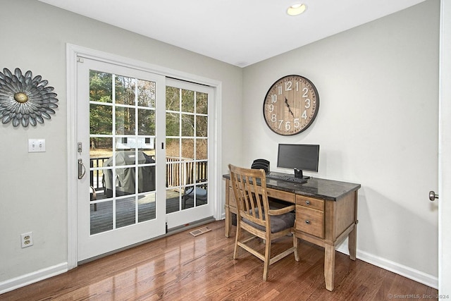 home office with hardwood / wood-style flooring