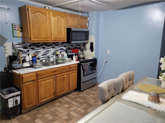 kitchen with stainless steel appliances, tasteful backsplash, and sink