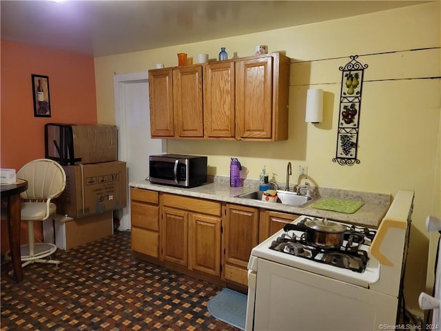 kitchen with sink and white gas range oven