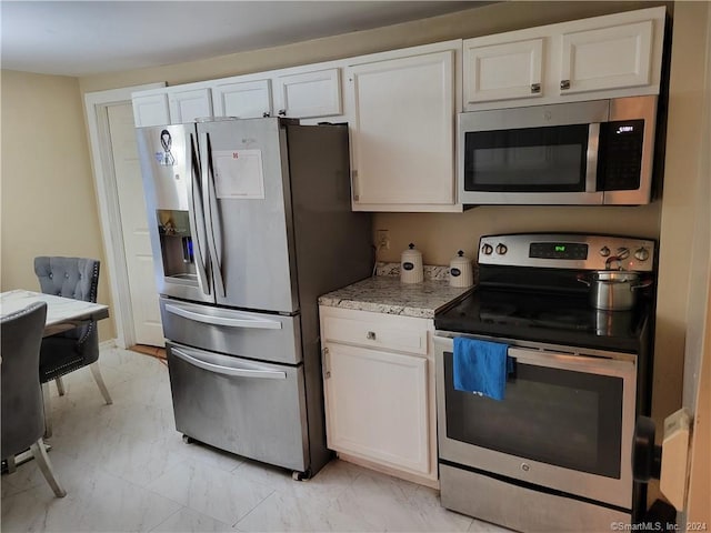 kitchen featuring white cabinetry and stainless steel appliances