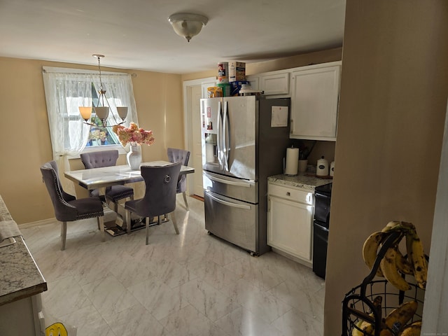 kitchen with white cabinetry, hanging light fixtures, black electric range oven, and stainless steel fridge