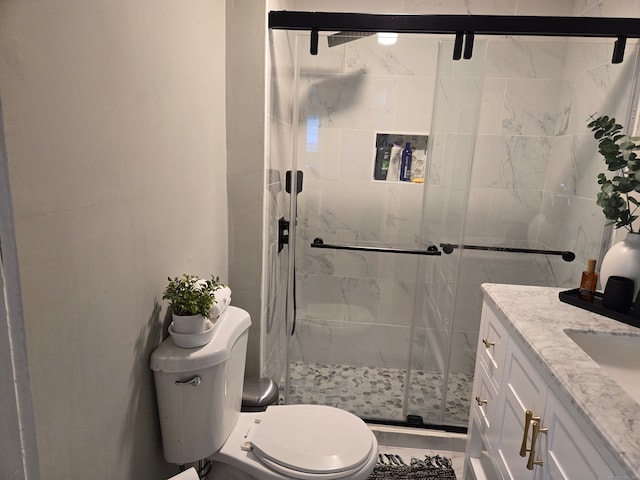 bathroom with vanity, toilet, and walk in shower