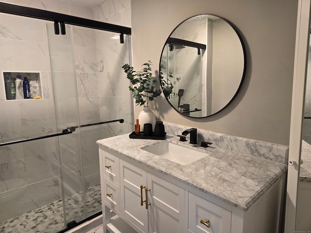 bathroom featuring vanity and a shower with shower door