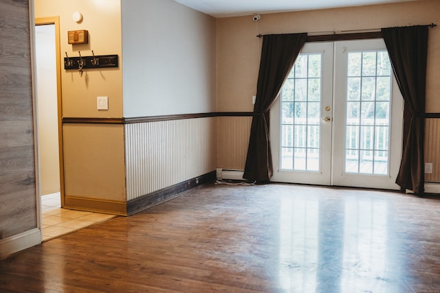 empty room featuring french doors and hardwood / wood-style flooring