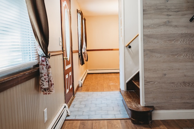 bathroom with wood-type flooring and a baseboard heating unit