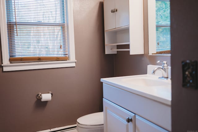 bathroom with vanity, toilet, and a baseboard radiator