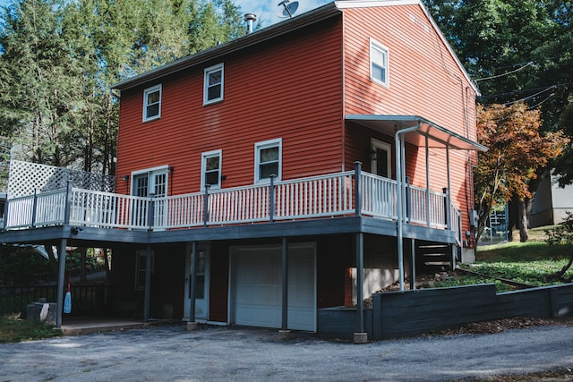 back of property with a garage