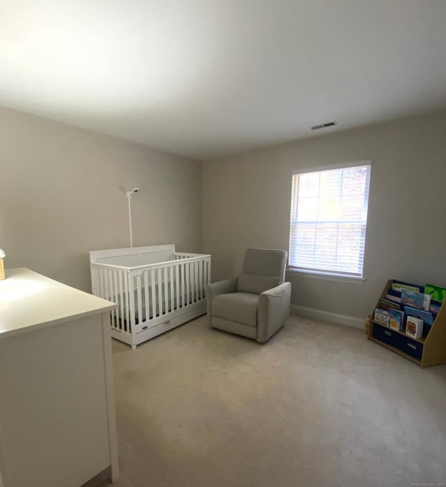 carpeted bedroom with a crib