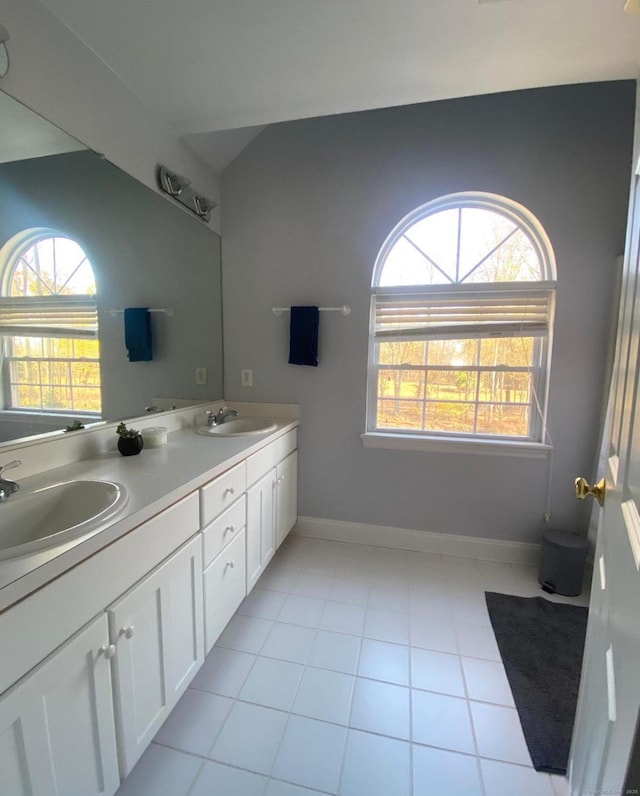 bathroom with tile patterned flooring, plenty of natural light, and vanity