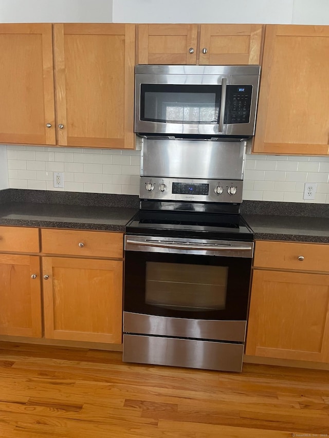 kitchen featuring tasteful backsplash, stainless steel appliances, and light hardwood / wood-style floors