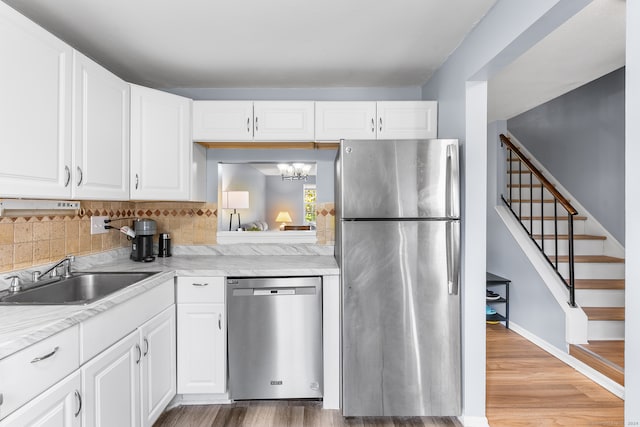 kitchen featuring white cabinetry, stainless steel appliances, and sink