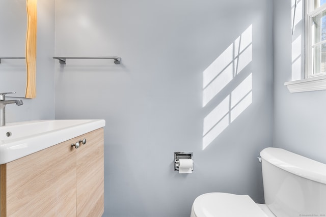 bathroom with toilet and vanity