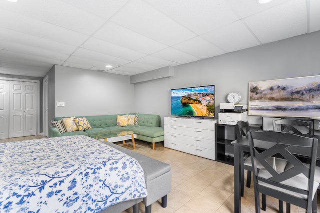 tiled bedroom with a paneled ceiling