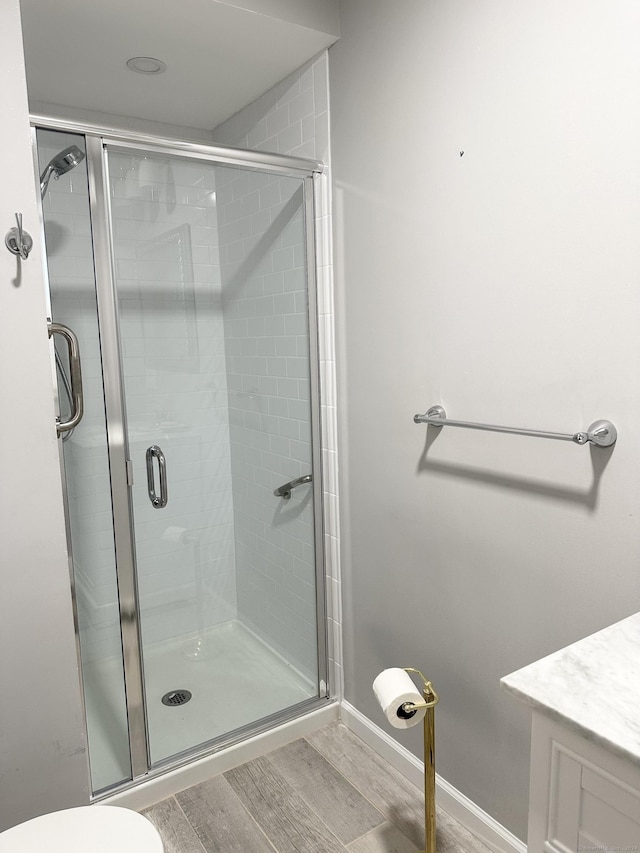 bathroom featuring an enclosed shower and toilet