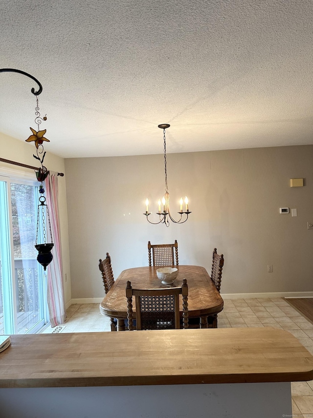 dining space featuring light tile patterned floors, a textured ceiling, and an inviting chandelier