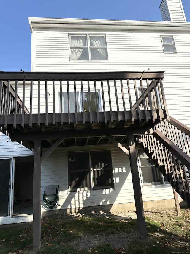 back of property with a wooden deck