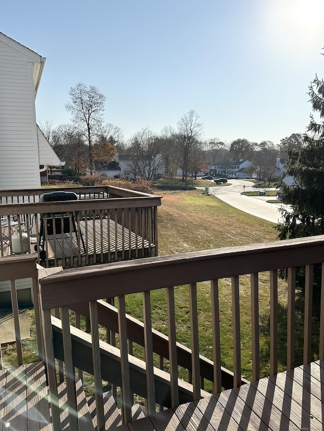 wooden terrace with a yard