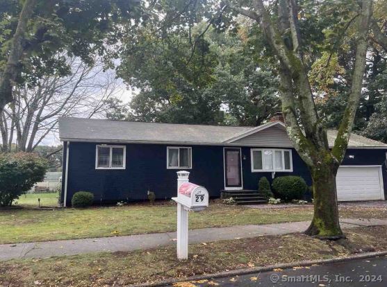 view of front of property with a front yard and a garage