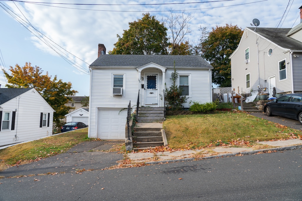 view of front facade featuring a front yard and cooling unit