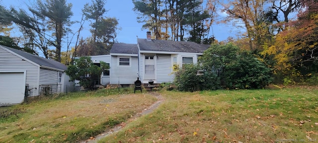 rear view of property featuring a yard