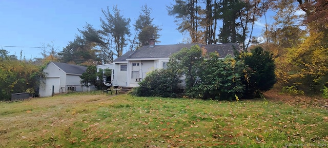 view of yard with an outbuilding and a garage