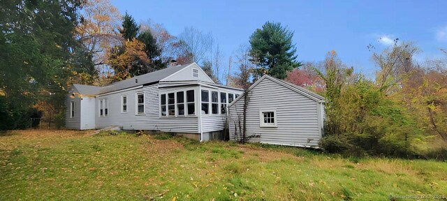 rear view of property featuring a yard