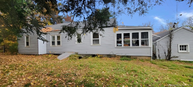 rear view of house with a yard