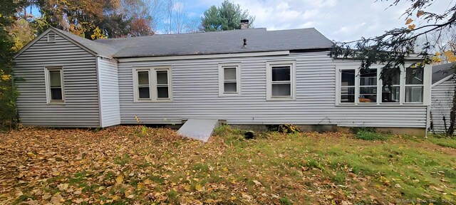 back of property with a lawn