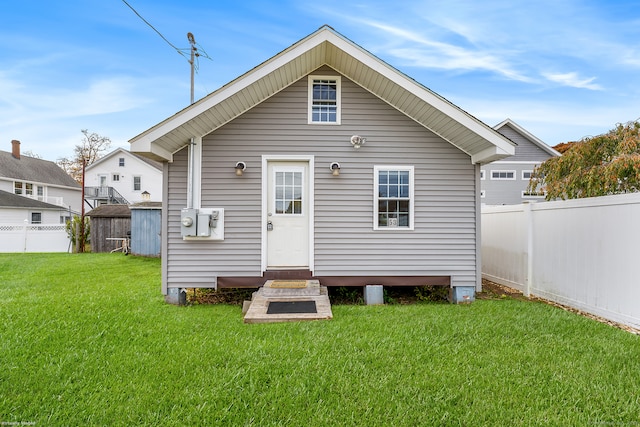 rear view of house with a lawn