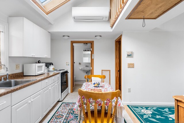 53 Breen Ave, Old Lyme, CT 06371 - kitchen with white appliances, a sink, a wall mounted AC, a skylight, and white cabinetry