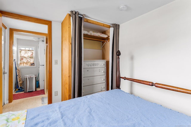 bedroom with a closet and light tile patterned floors