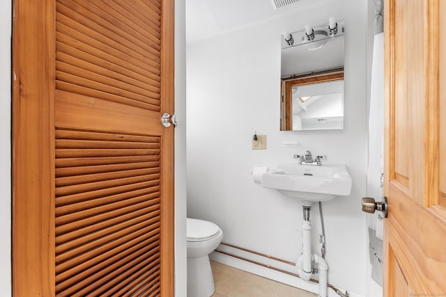 bathroom with tile patterned floors and toilet