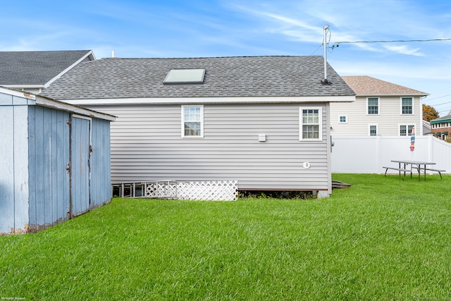 rear view of house with a yard