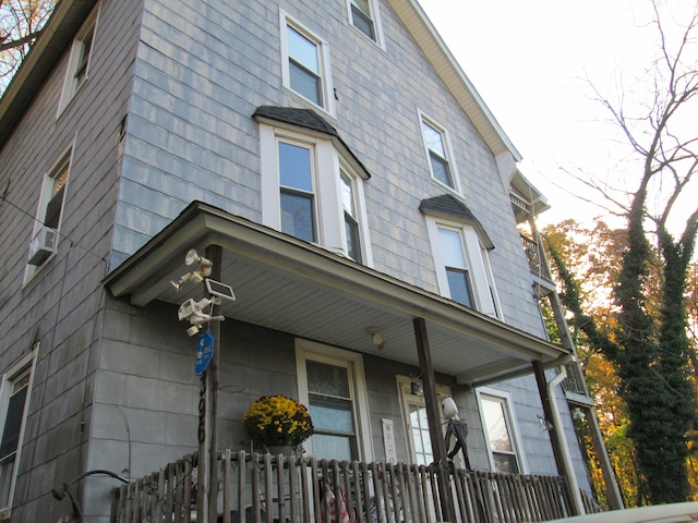 view of side of property featuring covered porch